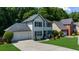 A view of the home's front exterior features a two-car garage, landscaped yard, and well-maintained lawn at 2688 Beddington Way, Suwanee, GA 30024