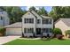 Charming two-story home featuring black shutters, a lush lawn, and well-maintained landscaping at 2688 Beddington Way, Suwanee, GA 30024
