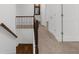 Upstairs hallway with carpet and railing. A bathroom and bedroom can be seen in the background at 2688 Beddington Way, Suwanee, GA 30024