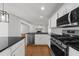 Modern kitchen featuring stainless steel appliances, granite countertops, and white cabinets at 2688 Beddington Way, Suwanee, GA 30024