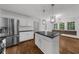Modern kitchen featuring stainless steel appliances, granite countertops, and an adjacent breakfast nook at 2688 Beddington Way, Suwanee, GA 30024