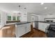 Modern kitchen featuring stainless steel appliances, granite countertops, and an adjacent breakfast nook at 2688 Beddington Way, Suwanee, GA 30024