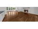 Living room features hardwood floors, fireplace, and large windows providing ample natural light at 2688 Beddington Way, Suwanee, GA 30024