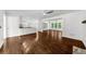 Open concept living room featuring wood floors, white walls, and natural light at 2688 Beddington Way, Suwanee, GA 30024