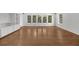Bright living room features hardwood floors and natural light coming from a wall of windows at 2688 Beddington Way, Suwanee, GA 30024