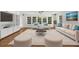 Cozy living room with hardwood floors, modern furnishings, and large windows providing ample natural light at 2688 Beddington Way, Suwanee, GA 30024