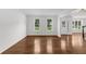 Spacious living room with hardwood floors, bright windows, and neutral paint at 2688 Beddington Way, Suwanee, GA 30024