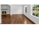 Cozy living room with wood floors, fireplace, and bright, sunny windows at 2688 Beddington Way, Suwanee, GA 30024
