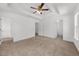 Spacious main bedroom with a tray ceiling, ceiling fan, and ensuite bathroom at 2688 Beddington Way, Suwanee, GA 30024