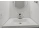 Modern powder room with a round mirror and sleek countertop at 2688 Beddington Way, Suwanee, GA 30024