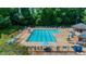 Aerial shot of a sparkling, well-maintained community swimming pool with lounge chairs and umbrellas at 2688 Beddington Way, Suwanee, GA 30024