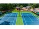 Two well-maintained blue and green tennis courts, perfect for sports enthusiasts at 2688 Beddington Way, Suwanee, GA 30024