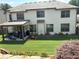 Rear view of home showcases an expansive lawn, patio, and well-maintained exterior at 4745 Belcrest Way, Cumming, GA 30040