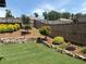 Expansive backyard with manicured lawn, rock retaining walls, and lush landscaping at 4745 Belcrest Way, Cumming, GA 30040