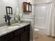 Bright bathroom featuring granite countertops and a shower-tub combo at 4745 Belcrest Way, Cumming, GA 30040