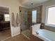 Bright bathroom features a glass-enclosed shower and a luxurious soaking tub at 4745 Belcrest Way, Cumming, GA 30040