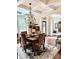 Elegant dining area with chandelier, hardwood floors, and bay window at 4745 Belcrest Way, Cumming, GA 30040