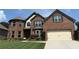 Charming two-story brick home featuring a manicured lawn and a two-car garage at 4745 Belcrest Way, Cumming, GA 30040