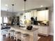 Well-appointed kitchen features granite countertops, stainless steel appliances, and island seating at 4745 Belcrest Way, Cumming, GA 30040