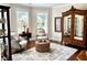 Cozy living room with hardwood floors, vintage armoire, and decorative rug at 4745 Belcrest Way, Cumming, GA 30040