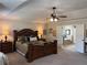 Large primary bedroom features tray ceilings and an ensuite bathroom with a soaking tub at 4745 Belcrest Way, Cumming, GA 30040