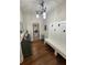 Mudroom with storage bench, laundry access, and hardwood flooring at 4745 Belcrest Way, Cumming, GA 30040