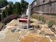 Charming patio with stone surface and rocking chairs perfect for relaxing outdoors at 4745 Belcrest Way, Cumming, GA 30040