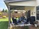 Cozy covered patio with comfortable seating, ideal for outdoor relaxation and dining at 4745 Belcrest Way, Cumming, GA 30040