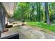 Spacious backyard with a patio perfect for outdoor seating and grilling, surrounded by lush greenery at 1328 Hidden Hills Pkwy, Stone Mountain, GA 30088