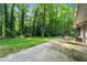 Large, lush backyard featuring a patio, grill, and ample space for outdoor activities and relaxation at 1328 Hidden Hills Pkwy, Stone Mountain, GA 30088