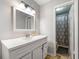 Bright bathroom with a large vanity and a view into the shower and toilet area at 1328 Hidden Hills Pkwy, Stone Mountain, GA 30088