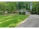 Charming home with a well-maintained lawn and a paved driveway leading to the entrance at 1328 Hidden Hills Pkwy, Stone Mountain, GA 30088