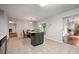 Open-concept kitchen with dining area and kitchen island, featuring tile flooring at 1328 Hidden Hills Pkwy, Stone Mountain, GA 30088