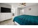 Spacious main bedroom with a large bed, a dresser, and neutral carpeting at 1328 Hidden Hills Pkwy, Stone Mountain, GA 30088