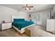 Cozy main bedroom featuring a large bed with bright blue comforter, white furniture, and backyard access at 1328 Hidden Hills Pkwy, Stone Mountain, GA 30088