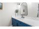 Stylish bathroom with blue vanity, white countertop, and decorative mirror for a modern look at 300 Brickworks Ne Cir # 302, Atlanta, GA 30307