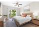 Bright bedroom with a ceiling fan, area rug, and balcony access that offers views of the outside at 300 Brickworks Ne Cir # 302, Atlanta, GA 30307