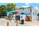 Exterior view of a building with colorful mural art, custom hats, and a vending machine at 300 Brickworks Ne Cir # 302, Atlanta, GA 30307