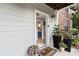Inviting entryway with potted plants, a 'hello' mat, and a glimpse of the bathroom at 300 Brickworks Ne Cir # 302, Atlanta, GA 30307