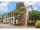 Charming two-story apartment building featuring brick accents, white siding, and covered balconies with wrought iron railings at 300 Brickworks Ne Cir # 302, Atlanta, GA 30307