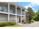 Charming condominium exterior with inviting balconies, greenery, and well-kept landscaping at 300 Brickworks Ne Cir # 302, Atlanta, GA 30307