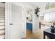 Hallway view of a stylish bathroom with blue vanity and the bright living area at 300 Brickworks Ne Cir # 302, Atlanta, GA 30307