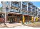 Exterior of Hawkers Asian Street Food restaurant with outdoor seating and apartment building view at 300 Brickworks Ne Cir # 302, Atlanta, GA 30307