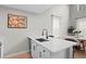 Modern kitchen island with a sink, dishwasher, and bar seating next to dining area at 300 Brickworks Ne Cir # 302, Atlanta, GA 30307