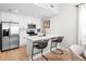 Modern kitchen with stainless steel appliances, quartz countertops, and bar seating at 300 Brickworks Ne Cir # 302, Atlanta, GA 30307