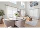Bright living room with a round dining table and large windows at 300 Brickworks Ne Cir # 302, Atlanta, GA 30307