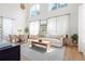 Bright living room with large windows, light wood floors, and white sofa at 300 Brickworks Ne Cir # 302, Atlanta, GA 30307