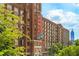 Exterior view of Ponce City Market, an impressive brick building with a view of the city skyline at 300 Brickworks Ne Cir # 302, Atlanta, GA 30307