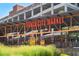 Exterior view of Ponce City Market entrance, surrounded by green foliage and visible signage at 300 Brickworks Ne Cir # 302, Atlanta, GA 30307