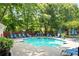 Community pool area with lounge chairs and umbrellas, offering a refreshing outdoor space at 300 Brickworks Ne Cir # 302, Atlanta, GA 30307